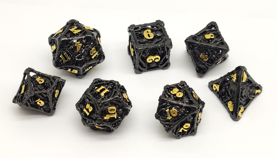無臭の携帯用DNDのダイスの金属、手は黒いRPGのダイスを切り分けた